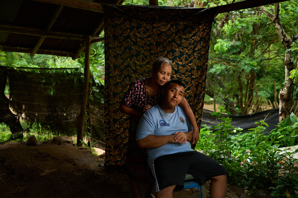 Ababa Moe, left, poses for a portrait with her son, Ababa, near their refugee camp in the Tak province of Thailand, Wednesday, Aug. 27, 2025. (AP Photo/Bram Janssen)