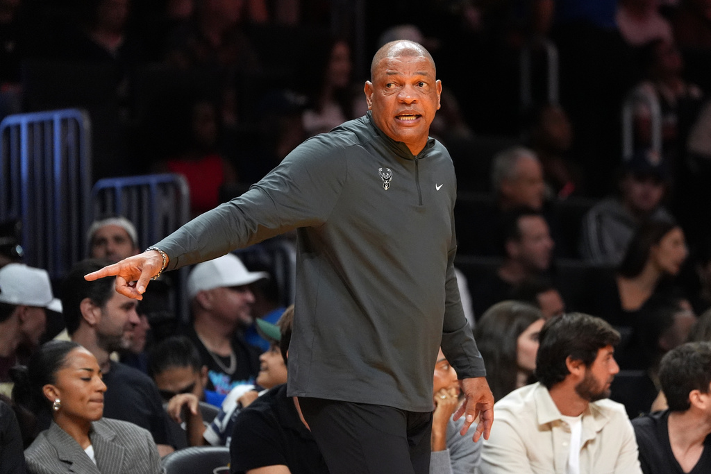 Milwaukee Bucks head coach Doc Rivers talks to players on the bench during the first half of an Emirates NBA Cup basketball game against the Miami Heat, Wednesday, Nov. 26, 2025, in Miami. (AP Photo/Rebecca Blackwell)