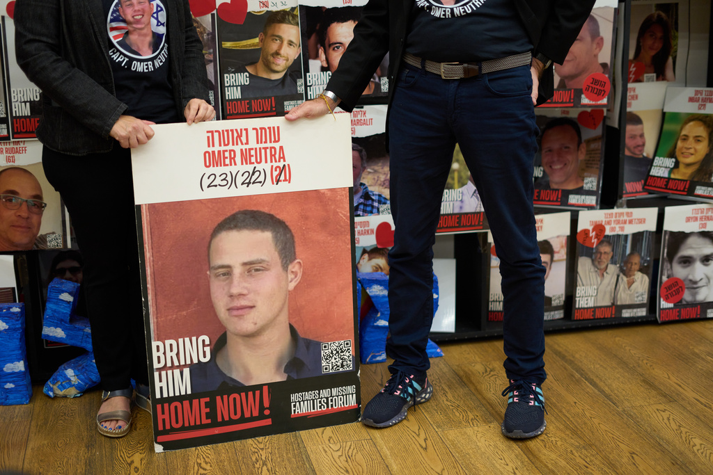Ronen and Orna Neutra, parents of Omer Neutra, a U.S.-Israeli citizen who was killed in the Hamas-led attacks on Oct. 7, 2023, present a photo of their son in Tel Aviv, Israel, Monday, Oct. 27, 2025. (AP Photo/Ariel Schalit)