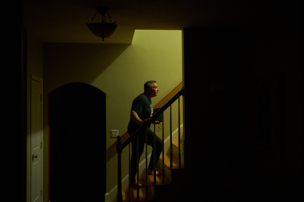 Chris Colocousis, who is still so shaken by a scam that took his retirement savings that he sometimes has trouble leaving his house, turns in for the night at his home in Raynham, Mass., Tuesday, March 10, 2026. (AP Photo/David Goldman)