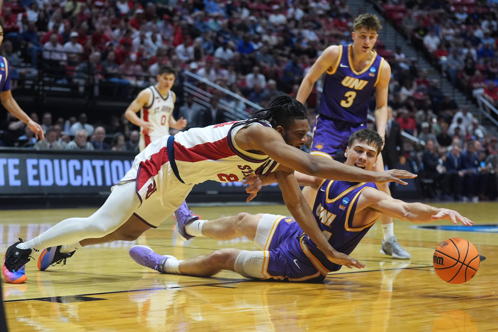 Northern Iowa forward Tristan Smith, below right, and St. John's forward Zuby Ejiofor battle for a loose ball during the first half in the first round of the NCAA college basketball tournament Friday, March 20, 2026, in San Diego. (AP Photo/Marcio Jose Sanchez)