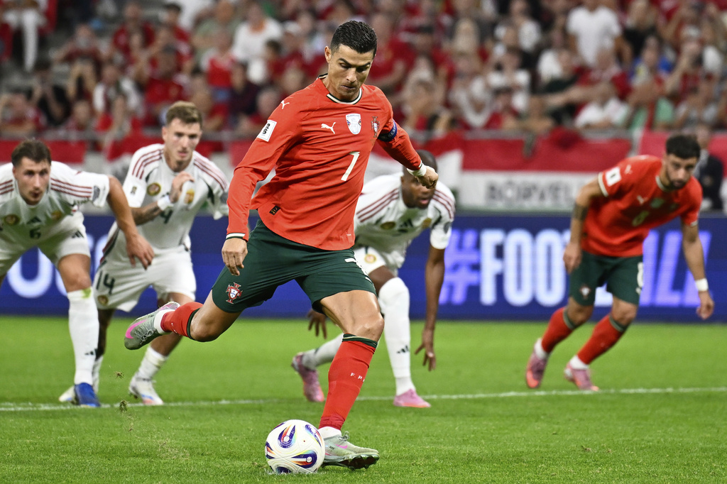 Portugal's Cristiano Ronaldo scores his side's second goal from the penalty spot during a World Cup 2026 group F qualifying soccer match between Hungary and Portugal at the Puskas Arena in Budapest, Tuesday, Sept. 9, 2025. (AP Photo/Denes Erdos)