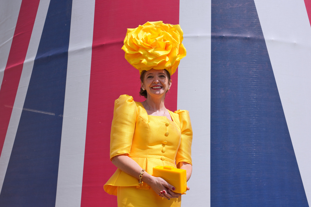 A Racegoer poses for photographers on the first day of the Royal Ascot horse race meeting in Ascot, England, Tuesday, June 16, 2026.(AP Photo/Kin Cheung)