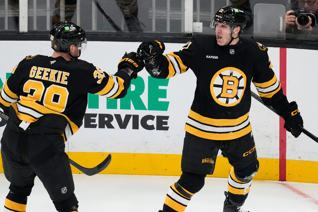 Boston Bruins center Alex Steeves, right, is congratulated by center Morgan Geekie (39) after his goal against the St. Louis Blues during the first period of an NHL hockey game, Thursday, Dec. 4, 2025, in Boston. (AP Photo/Charles Krupa)
