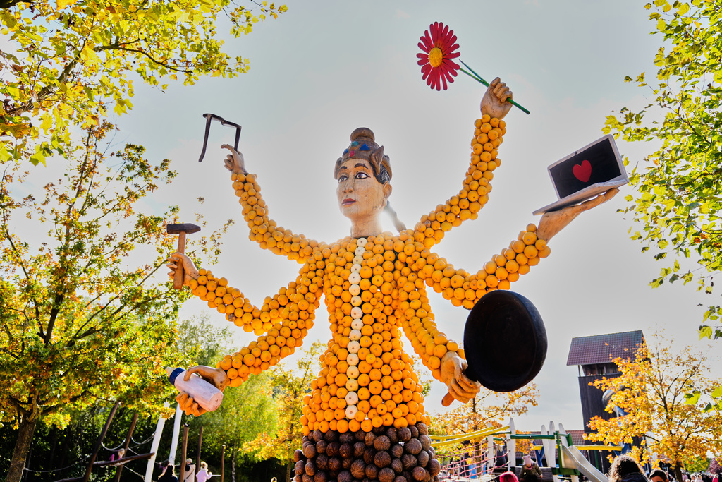 A pumpkin sculpture depicting a goddess with six arms, is displayed at Klaistow farm’s annual pumpkin festival, which this year celebrates “powerful women,” in Beelitz near Berlin, Germany, Tuesday, Oct. 21, 2025. (AP Photo/Markus Schreiber)