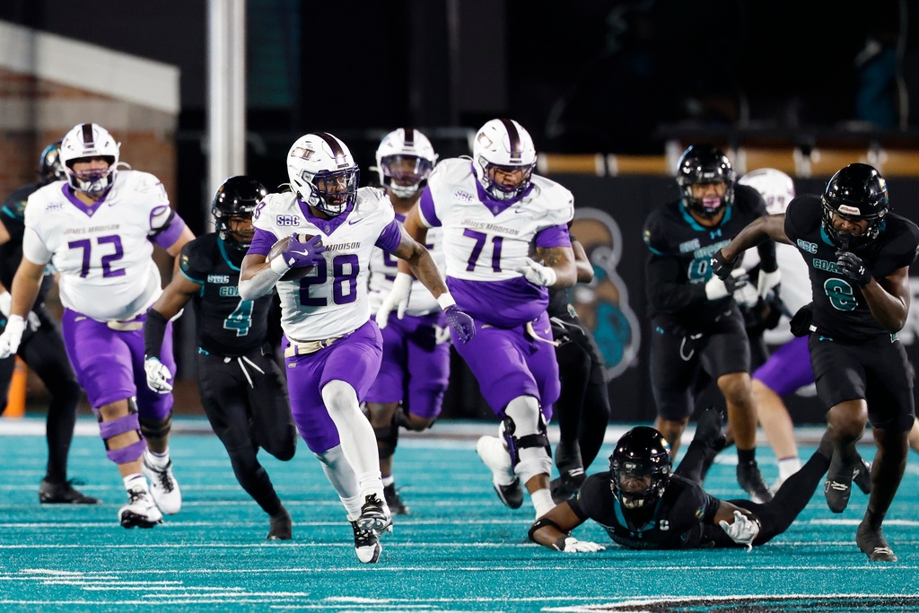James Madison running back Jobi Malary (28) breaks away for a touchdown run against Coastal Carolina during the second half of an NCAA college football game in Conway, S.C., Saturday, Nov. 29, 2025. (AP Photo/Nell Redmond)