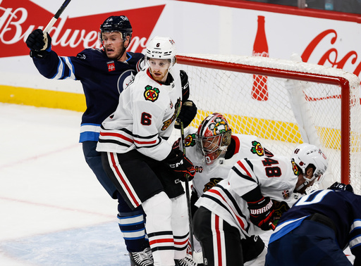 Chicago Blackhawks' Sam Rinzel (6) defends against Winnipeg Jets' Jonathan Toews, left, during second-period NHL hockey game action in Winnipeg, Manitoba, Thursday, Oct. 30, 2025. (John Woods/The Canadian Press via AP) Chicago Blackhawks' Sam Rinzel (6) defends against Winnipeg Jets' Jonathan Toews, left, during second-period NHL hockey game action in Winnipeg, Manitoba, Thursday, Oct. 30, 2025. (John Woods/The Canadian Press via AP)