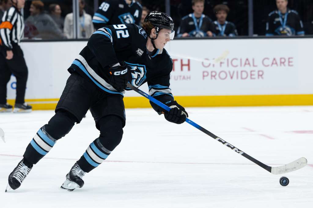 Utah Mammoth center Logan Cooley takes control of the puck during the first period of an NHL hockey game against the Vegas Golden Knights, Monday, Nov. 24, 2025, in Salt Lake City. (AP Photo/Anna Fuder)