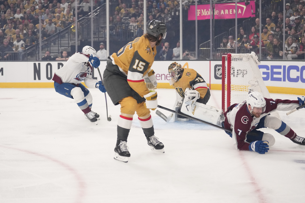 Colorado Avalanche left wing Gabriel Landeskog, left, scores on Vegas Golden Knights goaltender Carter Hart, second from right, as defenseman Noah Hanifin, second from left, and defenseman Devon Toews skate away during the first period in Game 3 of the Western Conference finals NHL hockey Stanley Cup playoff series Sunday, May 24, 2026, in Las Vegas. (AP Photo/Mark J. Terrill)