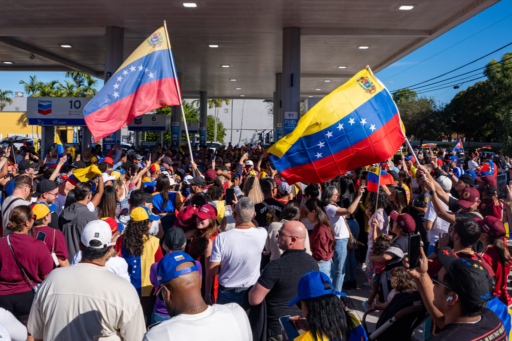 People celebrate after President Donald Trump announced Venezuelan President Nicolás Maduro had been captured and flown out of the country, in Doral, Fla., Saturday, Jan. 3, 2026. (AP Photo/Jen Golbeck)
