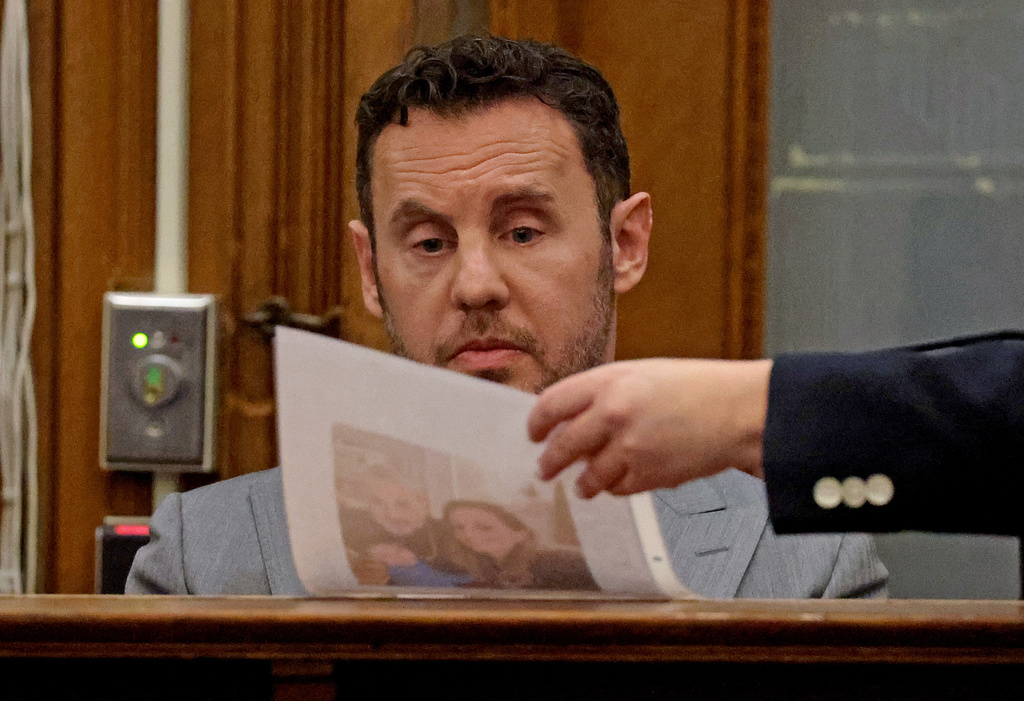 William Fastow, Ana Walshe's boyfriend, looks at a picture of Ana while on the witness stand during Brian Walshe's trial for murdering his wife Ana, Thursday, Dec. 4, 2025, in Dedham, Mass. (Matt Stone/The Boston Herald via AP, Pool)