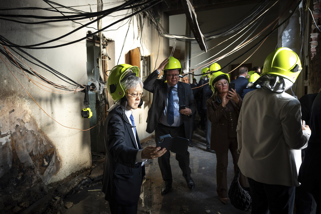 In this photo provided by the Press Service Of Prime minister Of Ukraine on Sept. 8, 2025, representatives of diplomatic missions check destruction at the Cabinet of Ministers building damaged after a Russian attack in Kyiv, Ukraine. (Press Service Of Prime minister Of Ukraine via AP)