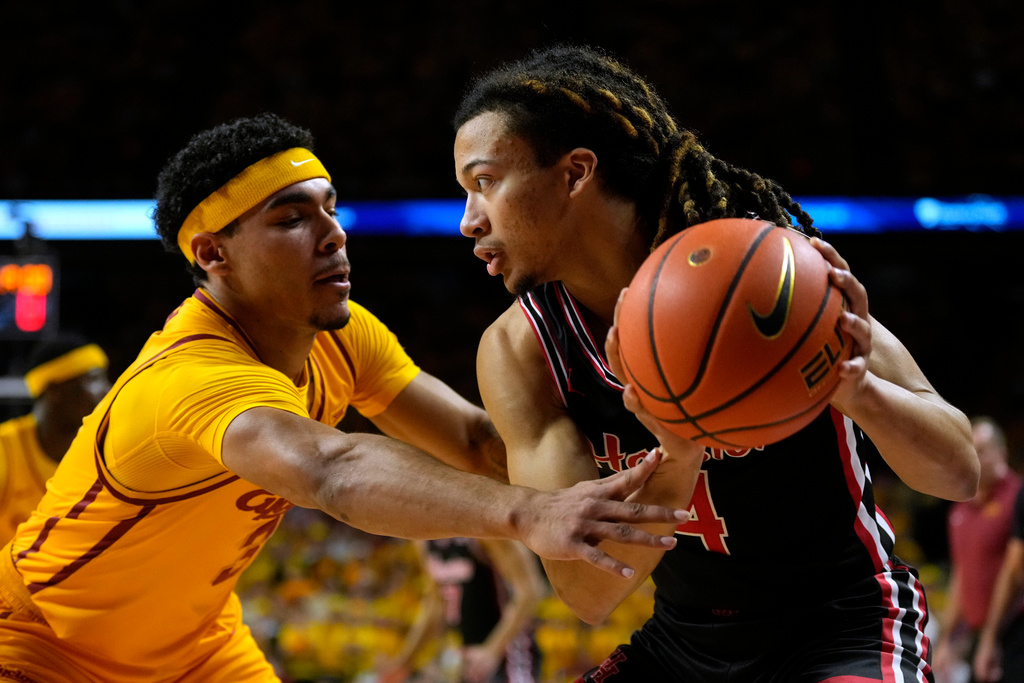 Iowa State guard Tamin Lipsey, left, tries to steal the ball from Houston guard Kingston Flemings (4) during the first half of an NCAA college basketball game, Monday, Feb. 16, 2026, in Ames, Iowa. (AP Photo/Charlie Neibergall)