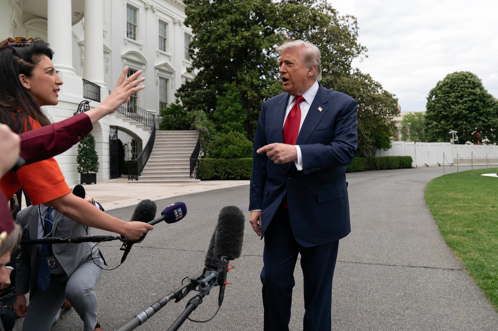 President Donald Trump speaks to reporters as he walks to board Marine One on the South Lawn of the White House, Friday, May 8, 2026, in Washington. (AP Photo/Jose Luis Magana)