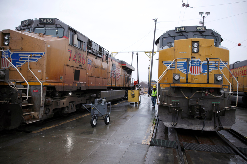 FILE - A Union Pacific worker walks between two locomotives that are being serviced in a railyard in Council Bluffs, Iowa, on Dec. 15, 2023. (AP Photo/Josh Funk, File)