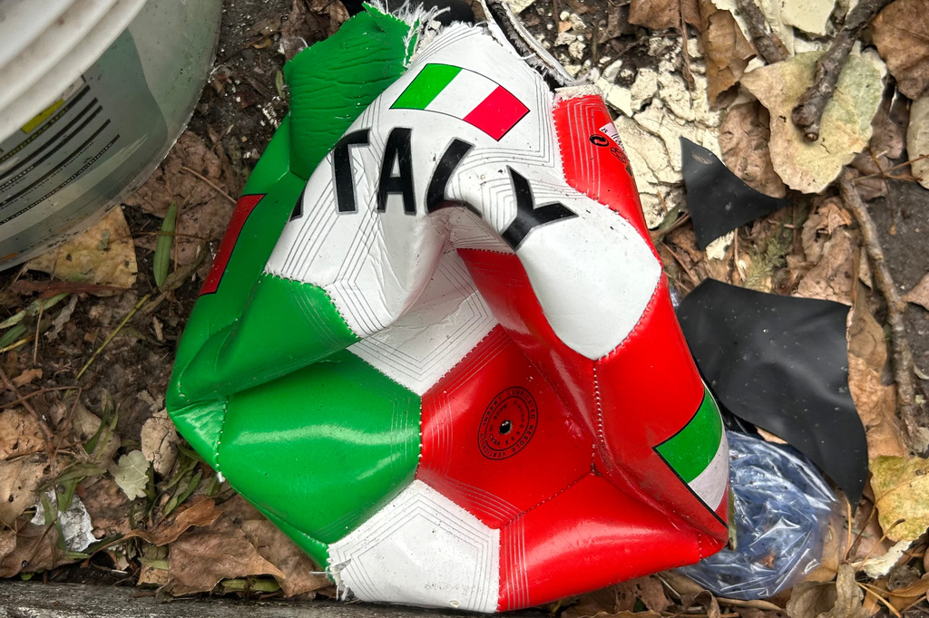 A broken soccer ball is pictured on a street in Rome, Wednesday, April 1, 2026. (AP Photo/Gregorio Borgia)