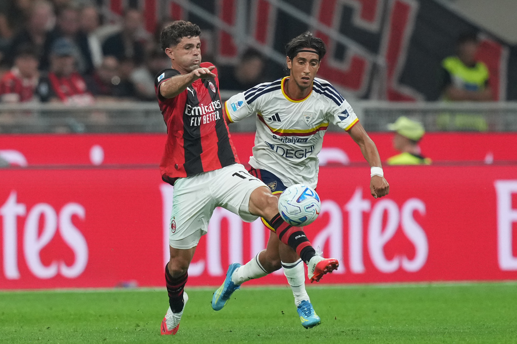 AC Milan's Christian Pulisic, left, battles for the ball with Lecce's Youssef Maleh during the Serie A soccer match between AC Milan and Lecce, in Milan, Italy, Sunday, Sept. 20, 2026. (AP Photo/Antonio Calanni)