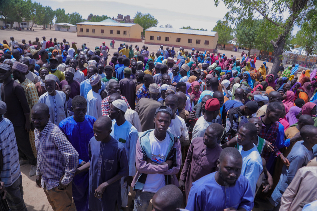 People gather for a meeting with the Borno state governor in Pulka, Nigeria, Friday, March 6, 2026, after they fled an attack by Islamic militants in Ngoshe. (AP Photo/Jossy Ola)