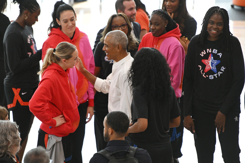 Former President Barack Obama greets WNBA All-Star Paige Bueckers, left, during a practice at the Obama Presidential Center in Chicago, Friday, July 24, 2026. (AP Photo/Paul Beaty)