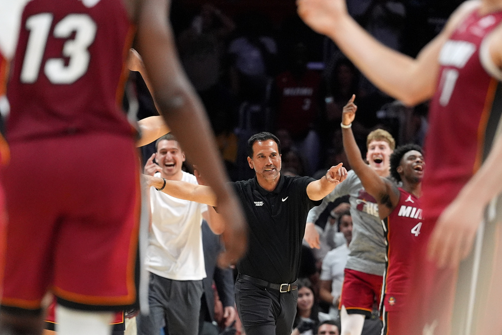 Miami Heat head coach Erik Spoelstra, center, and players react during the second half of an NBA basketball game against the Washington Wizards, as center Bam Adebayo (13) plays on his way to scoring 83 points, the second-highest single game total in NBA history, in an NBA basketball game, Tuesday, March 10, 2026, in Miami. (AP Photo/Rebecca Blackwell)