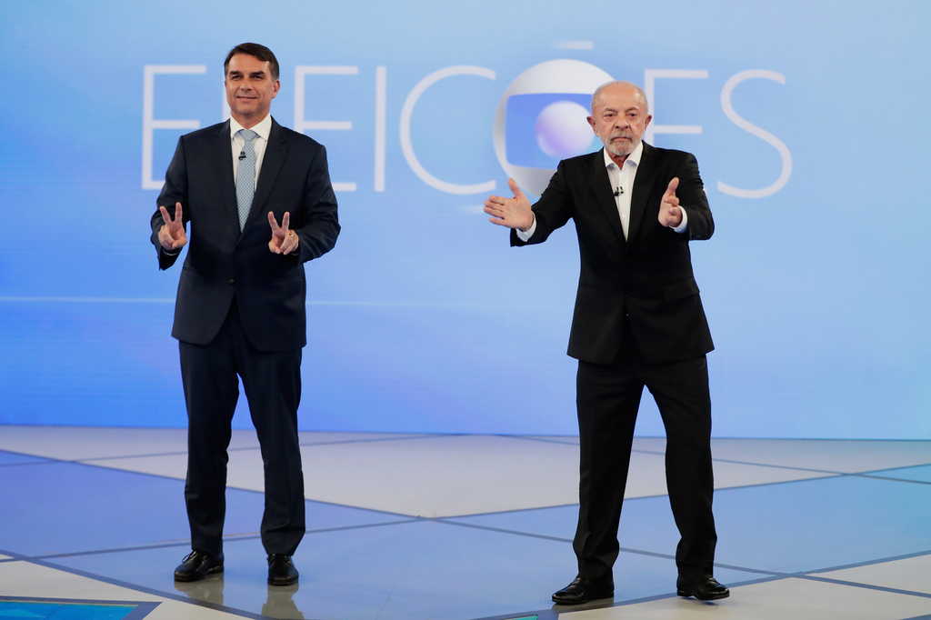 Brazilian President Luiz Inacio Lula da Silva, right, who is running for reelection, and opposition presidential candidate Sen. Flavio Bolsonaro attend a televised presidential debate days before the presidential runoff election in Rio de Janeiro, Friday, Oct. 23, 2026. (AP Photo/Bruna Prado)