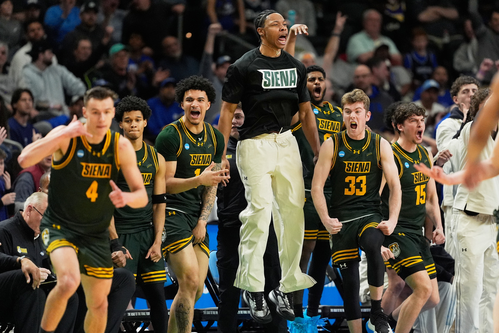 Siena celebrates after scoring against Duke during the second half in the first round of the NCAA college basketball tournament, Thursday, March 19, 2026, in Greenville, S.C. (AP Photo/Chris Carlson)