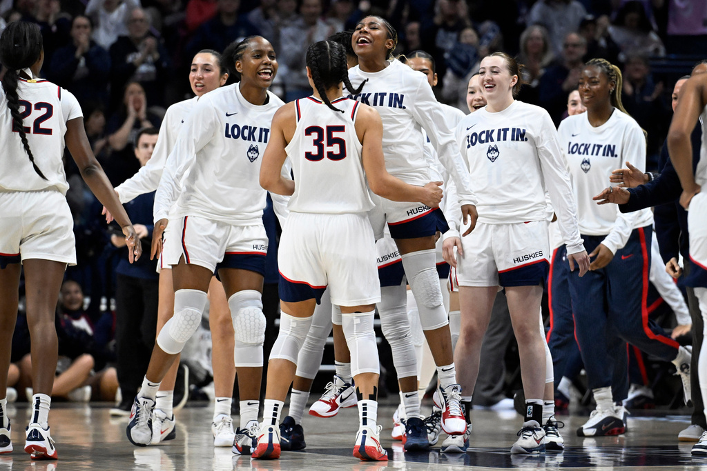UConn guard Azzi Fudd (35) is greeted by guards Blanca Quinonez, center left, and Kelis Fisher, center right, during the first half in the second round of the NCAA college basketball tournament against Syracuse, Monday, March 23, 2026, in Storrs, Conn. (AP Photo/Jessica Hill)