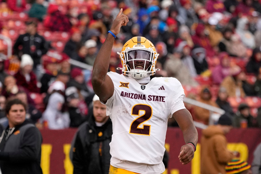 Arizona State quarterback Jeff Sims celebrates after a touchdown run during the first half of an NCAA college football game against Iowa State, Saturday, Nov. 1, 2025, in Ames, Iowa. (AP Photo/Charlie Neibergall)