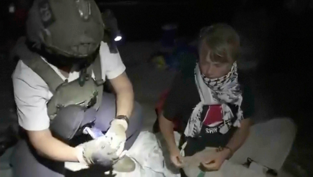This image taken from video released by the Israeli Foreign Ministry claims to show activist Greta Thunberg, right, as she is removed after the Israeli navy intercepted the Global Sumud Flotilla carrying humanitarian aid towards Gaza on Wednesday, Oct. 1, 2025. (Israeli Foreign Ministry via AP)