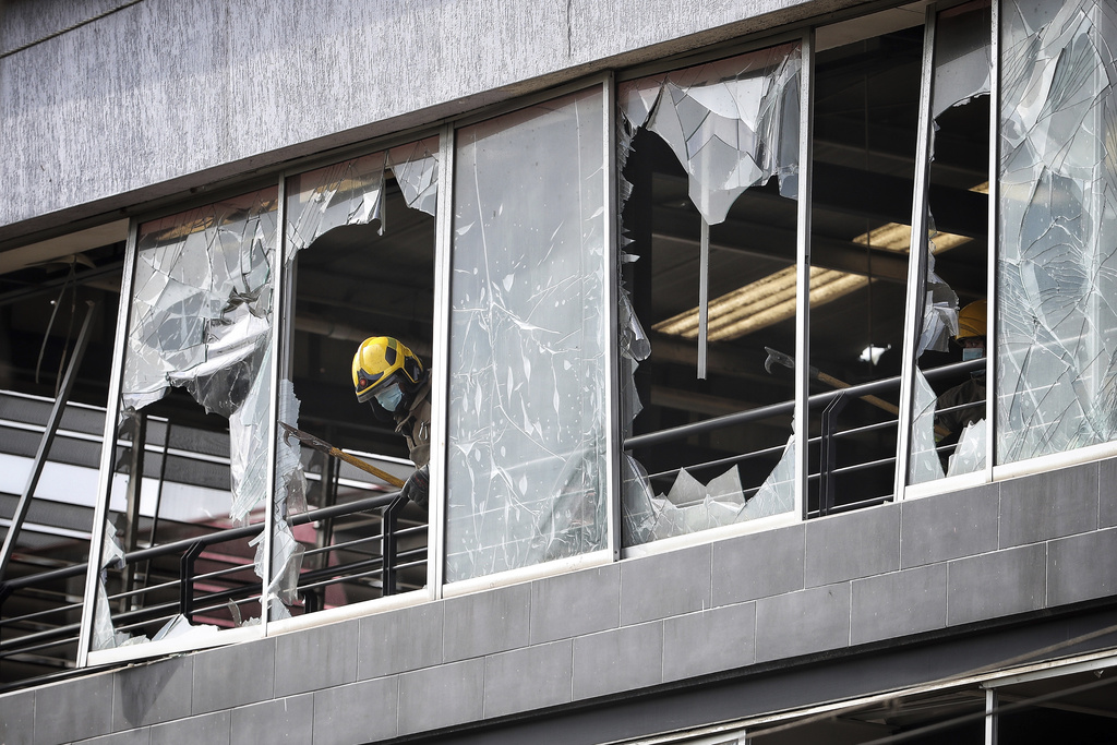 A firefighter works in a building damaged a day earlier by a car bomb explosion outside an Air Force base in Cali, Colombia, Friday, Aug. 22, 2025. (AP Photo/Santiago Saldarriaga)