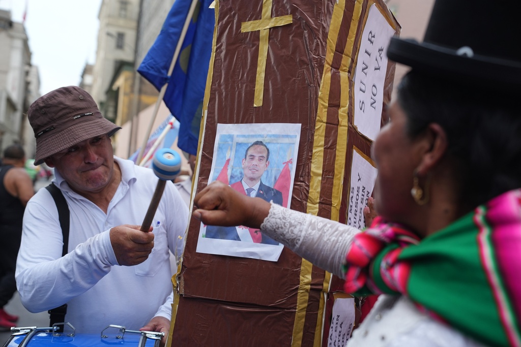 Demonstrators celebrate after learning Congress voted to remove interim President Jose Jeri as he faces corruption allegations, outside the site where lawmakers met in Lima, Peru, Tuesday, Feb. 17, 2026. (AP Photo/Guadalupe Pardo)