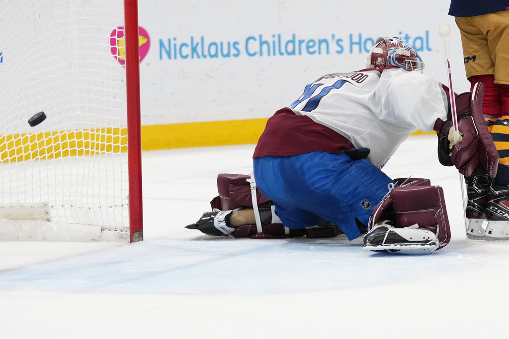 The puck gets past Colorado Avalanche goaltender Scott Wedgewood on a goal scored by Florida Panthers defenseman Aaron Ekblad during the second period of an NHL hockey game, Sunday, Jan. 4, 2026, in Sunrise, Fla. (AP Photo/Lynne Sladky)