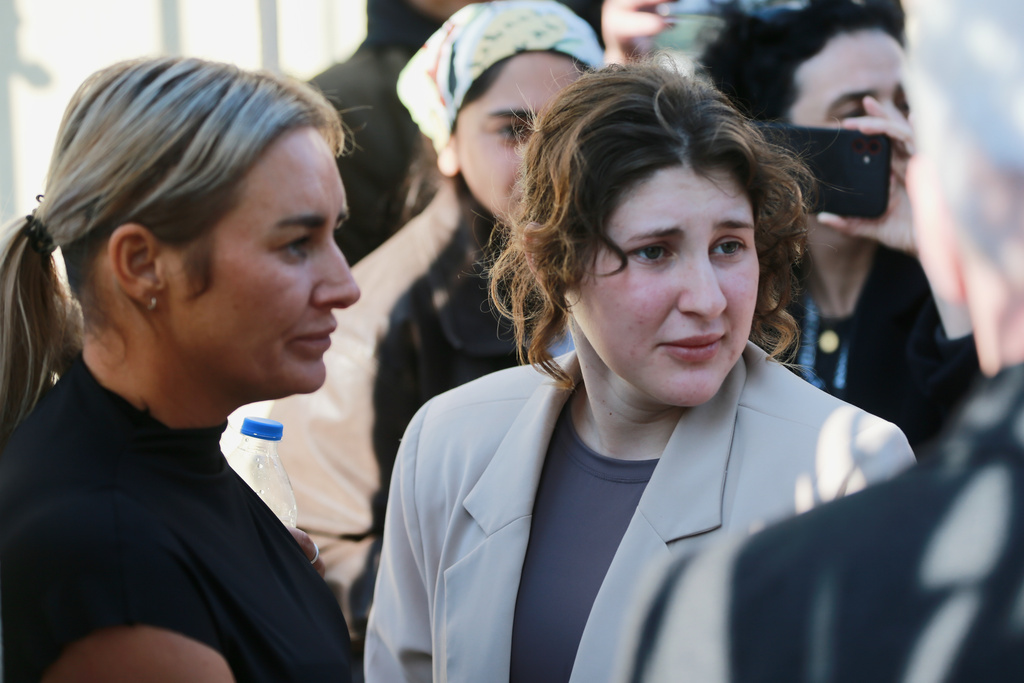 Bella May Culley, front right, 19-year-old, who was arrested upon arrival at the Tbilisi Airport in May and accused of attempting to smuggle marijuana and hashish into the country, speaks to journalists after she was released from prison near the court building in Tbilisi, Georgia, on Monday, Nov. 3, 2025, as her mother Lyanne Kennedy, stands on the left. (AP Photo/Zurab Tsertsvadze)