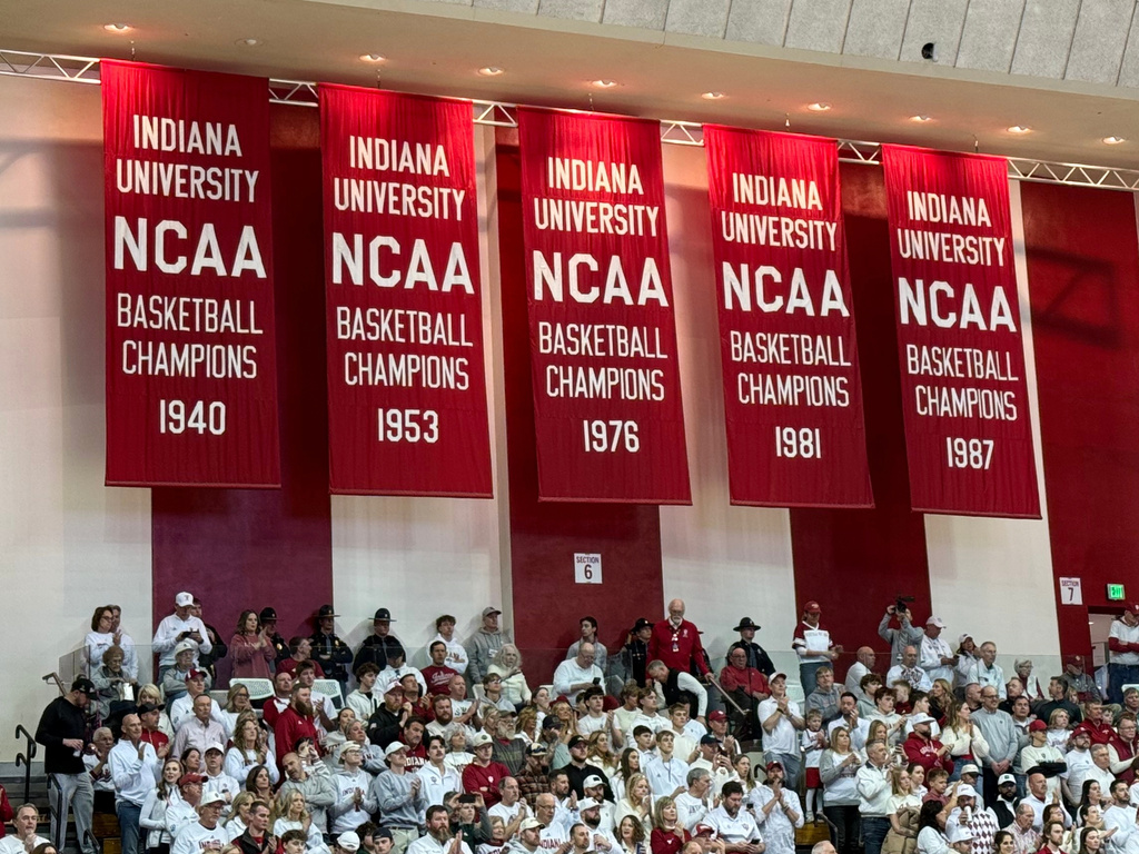 Championship banners, including the Indiana Hoosiers 1975-76 national championship team, the last undefeated men's Division I team to win the championship, hang in the arena before a basketball game against Michigan State, March 1, 2026, in Bloomington, Ind. (AP Photo/Mike Marot)