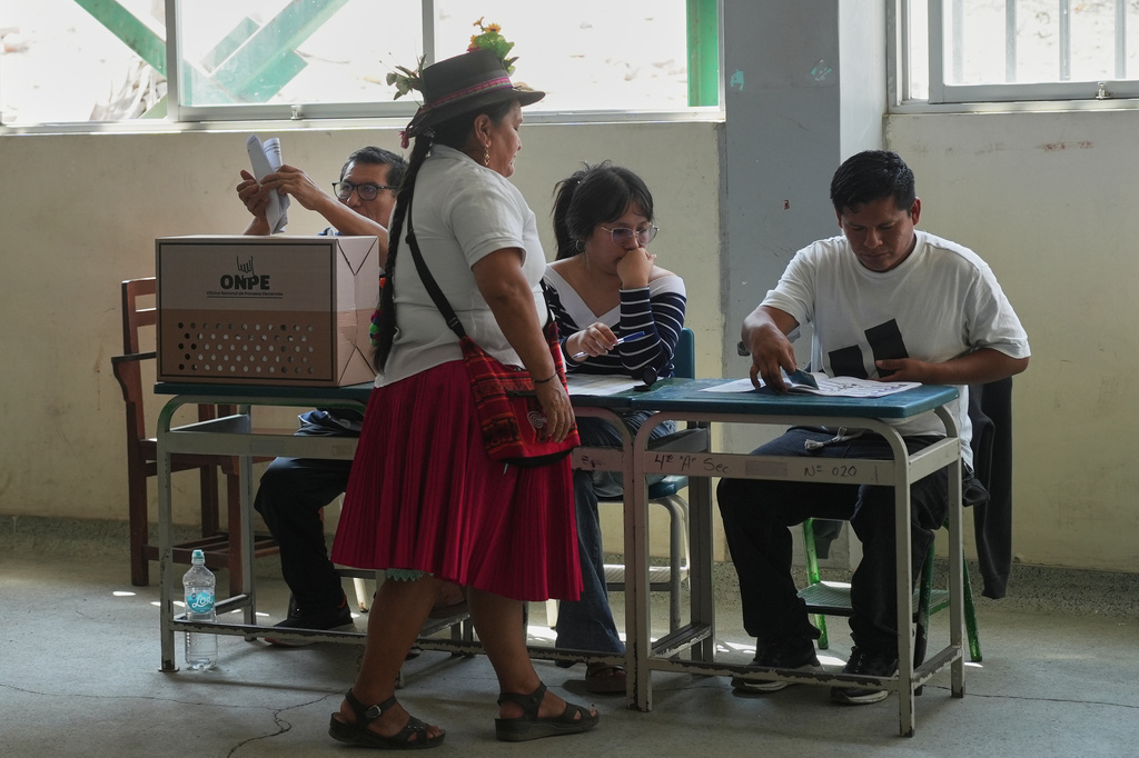 A woman votes during general elections in Lima, Peru, Sunday, April 12, 2026. (AP Photo/Guadalupe Pardo)