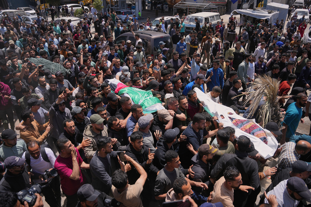 Palestinians carry the bodies of Izz al-Din al-Haddad, the leader of Hamas' Qassam Brigades, center, along with those of his daughter, right, and wife, who were killed in an Israeli strike, during their funeral in Gaza City, Saturday, May 16, 2026. (AP Photo/Abdel Kareem Hana)