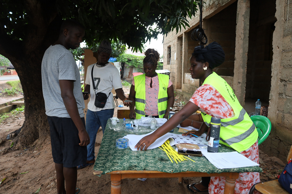 Voters prepare to cast their ballots during a referendum on granting new presidential powers, in Bissau, Guinea Bissau, Sunday, Aug. 30, 2026. (AP Photo/Darcicio Barbosa)