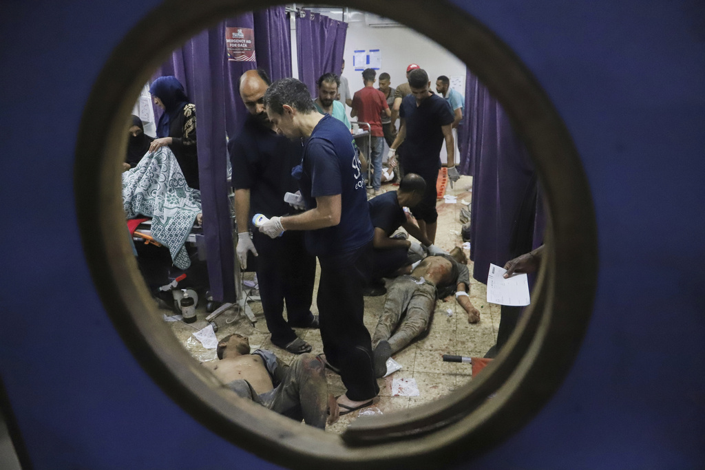 FILE - Palestinians who were injured during a food distribution at a center run by the Gaza Humanitarian Foundation, a U.S.-backed organization approved by Israel, receive treatment on the floor of Nasser Hospital in Khan Younis, southern Gaza Strip, Saturday, July 19, 2025. (AP Photo/Mariam Dagga, File)
