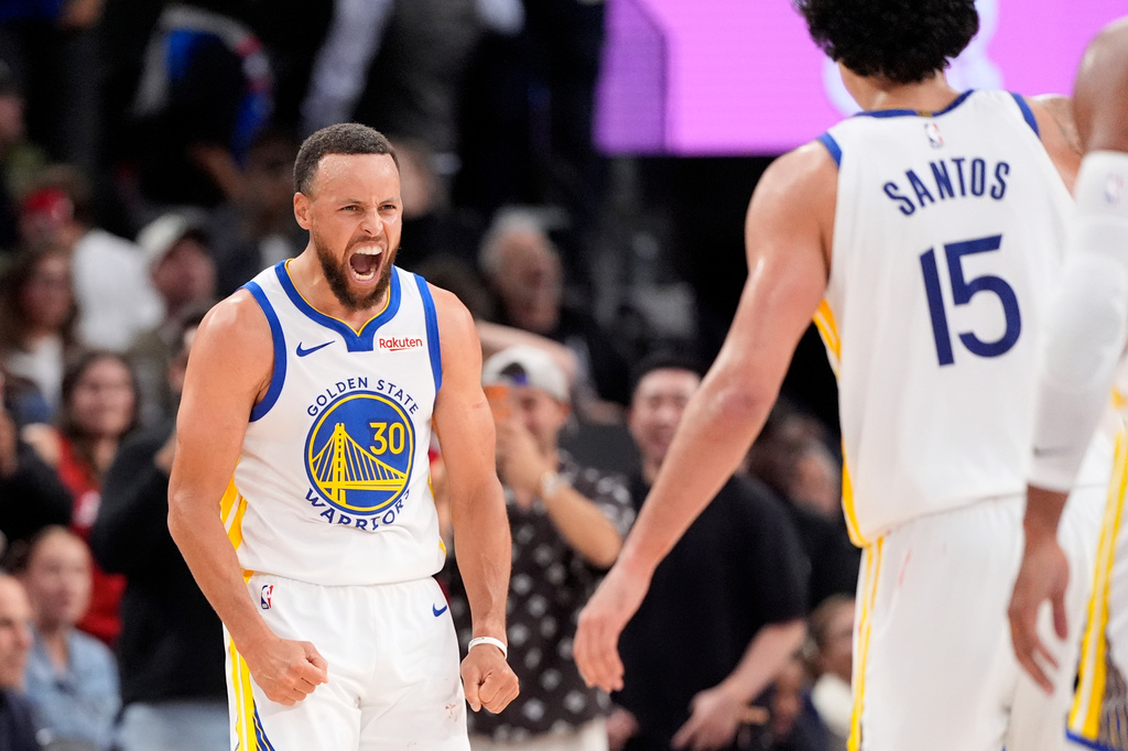 Golden State Warriors guard Stephen Curry, left, celebrates with forward Gui Santos after scoring during the second half of an NBA play-in tournament basketball game against the LA Clippers, Wednesday, April 15, 2026, in Inglewood, Calif. (AP Photo/Mark J. Terrill)