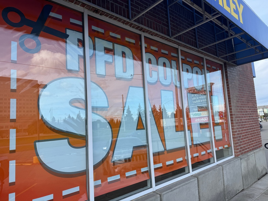 A sale advertisement related to the issuance of Alaska Permanent Fund Dividend, or PFD, checks hangs inside a furniture store in Anchorage, Alaska, Tuesday, Sept. 23, 2025. (AP Photo/Mark Thiessen)