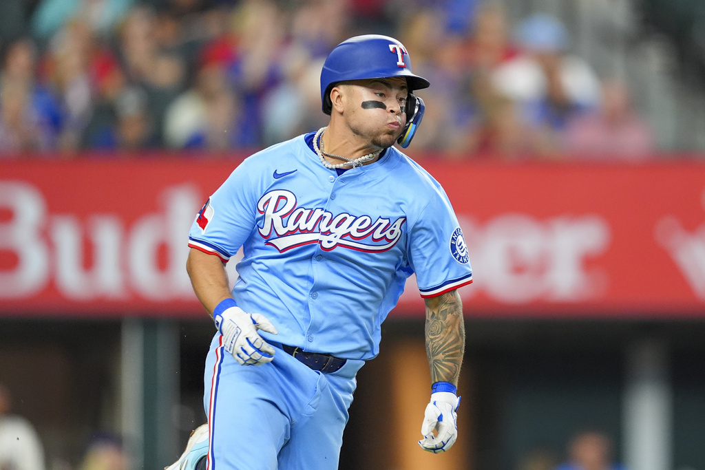 Texas Rangers' Cody Freeman runs after hitting a single during the sixth inning of a baseball game against the Miami Marlins on Sunday, Sept. 21, 2025, in Arlington, Texas. (AP Photo/Ronaldo Bolaños)
