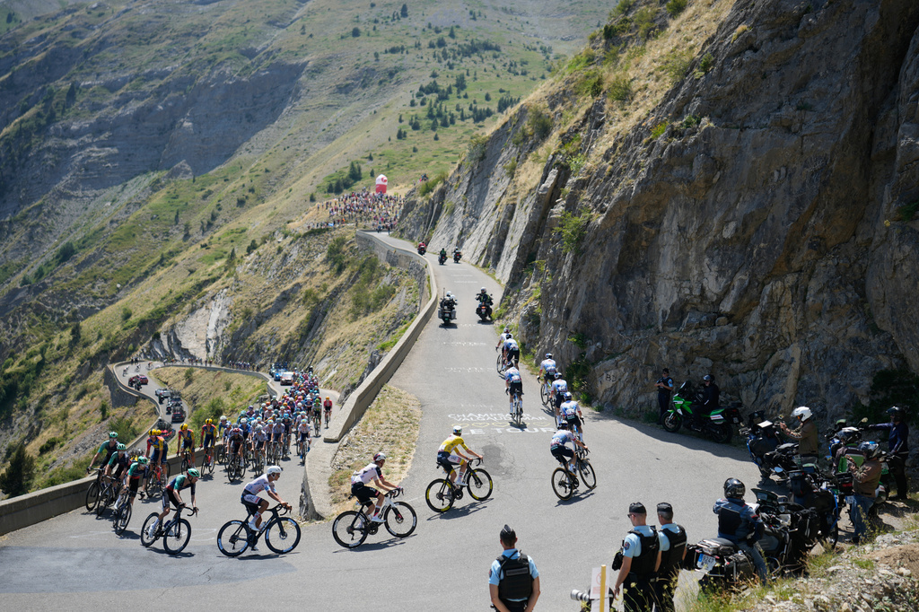 Slovenia's Tadej Pogacar, wearing the overall leader's yellow jersey, rides in the pack during the nineteenth stage of the Tour de France cycling race with start in Gap and finish in Alpe d'Huez, France, Friday, July 24, 2026. (AP Photo/Mosa'ab Elshamy)
