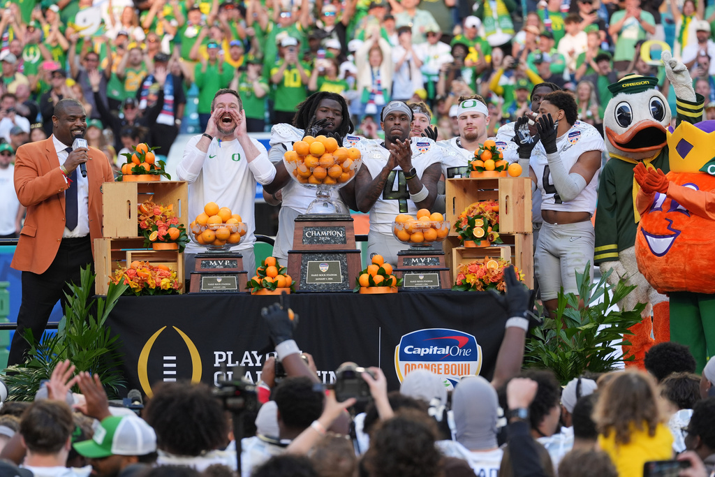 Oregon head coach Dan Lanning, second left, shouts as he celebrates with his players after defeating Texas Tech in the Orange Bowl College Football Playoff quarterfinal game, Thursday, Jan. 1, 2026, in Miami Gardens, Fla. (AP Photo/Rebecca Blackwell)