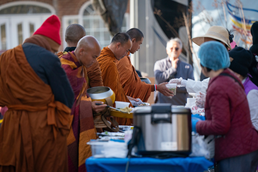 Buddhist monks who are participating in the, "Walk For Peace," get lunch Thursday, Jan. 8, 2026, in Saluda, S.C. (AP Photo/Allison Joyce)