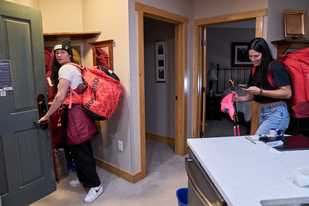 After lunch in the condo they share during training, skiers Jackie Wiles, of Portland, Ore., left, and Bella Wright, of Salt Lake City, leave to meet members of the U.S. Women's Ski Team at Copper Mountain, Colo., Nov. 19, 2025. (AP Photo/Jacquelyn Martin)