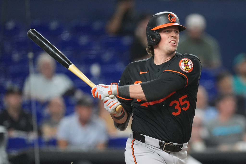 Baltimore Orioles' Adley Rutschman watches his ball after hitting a double to bring home Taylor Ward, during the fifth inning of a baseball game against the Miami Marlins, Wednesday, May 6, 2026, in Miami. (AP Photo/Rebecca Blackwell)