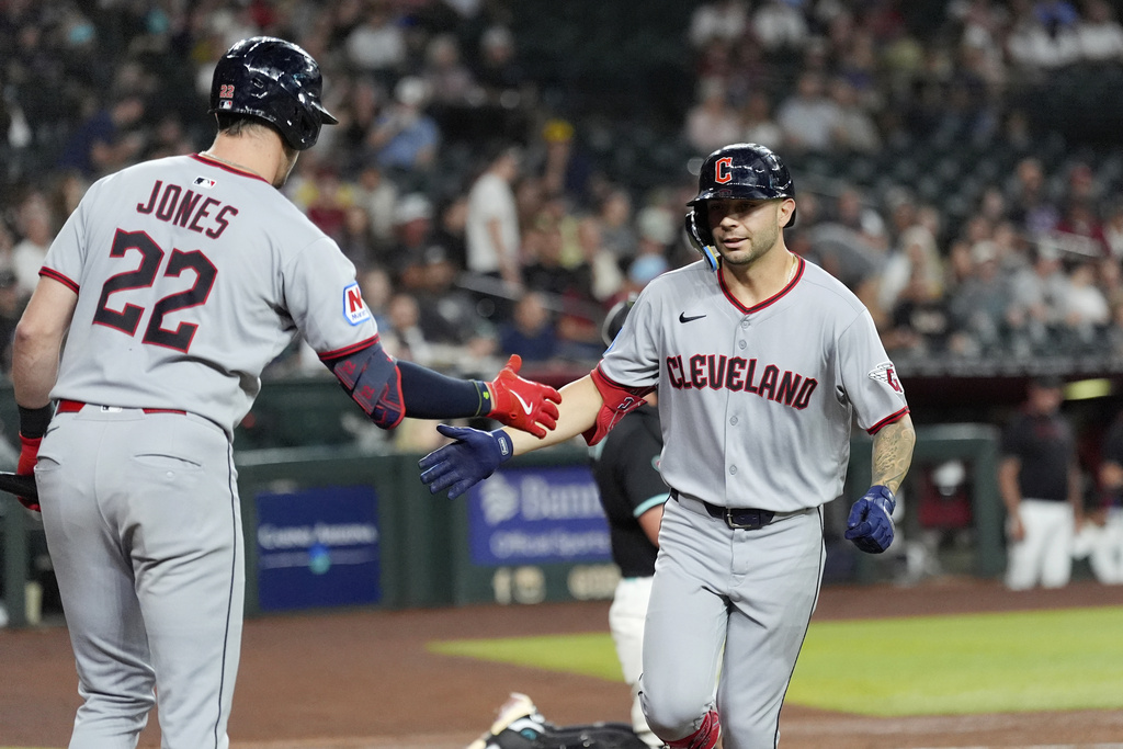 Cleveland Guardians' C.J. Kayfus, right, celebrates his home run against the Arizona Diamondbacks with Guardians' Nolan Jones (22) during the second inning of a baseball game Monday, Aug. 18, 2025, in Phoenix. (AP Photo/Ross D. Franklin)
