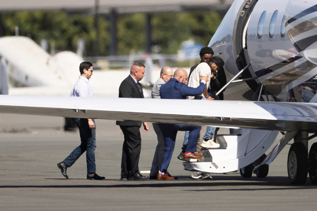 FILE - Harjinder Singh is escorted onto an airplane by Florida Lt. Gov. Jay Collins and law enforcement on Thursday, Aug. 21, 2025, in Stockton, Calif. (AP Photo/Benjamin Fanjoy, file)