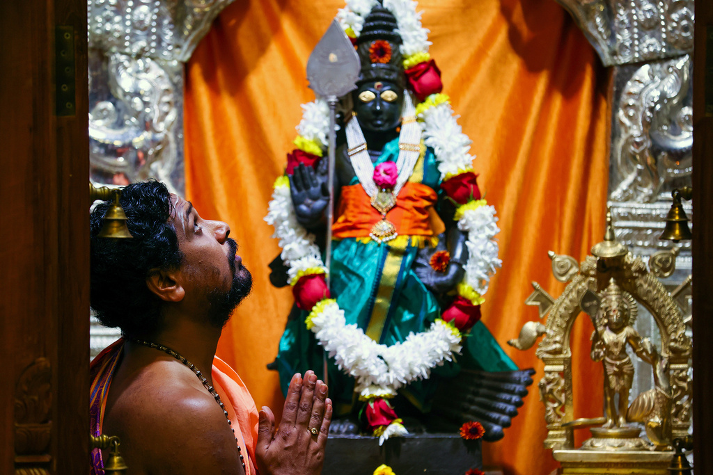 FILE - A priest prays inside a shire at the Karya Siddhi Hanuman Temple in Frisco, Texas, Oct. 22, 2022, as worshippers celebrated Dhanteras, which is the first night of the Hindu holiday Diwali. (AP Photo/Andy Jacobsohn, File)
