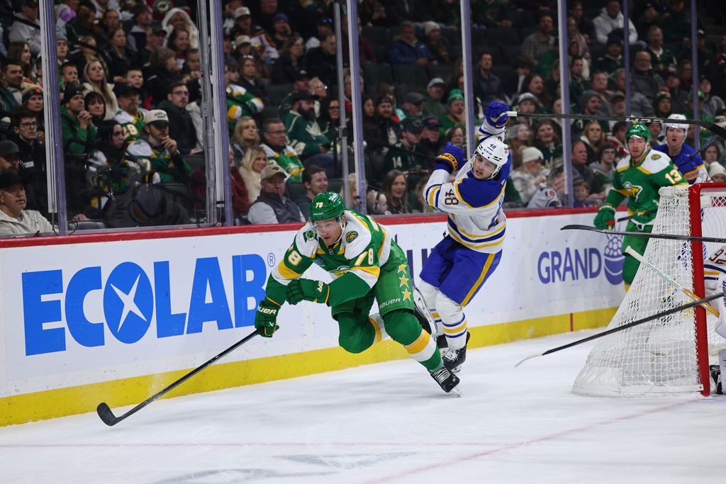 Minnesota Wild center Nico Sturm (78) and Buffalo Sabres center Tyson Kozak (48) battled for the puck during the first period of an NHL hockey game Saturday, Nov. 29, 2025, in St. Paul, Minn. (AP Photo/Adam Bettcher)